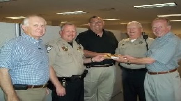 news um men present copies of historic book of devotions to sheriffs department 0